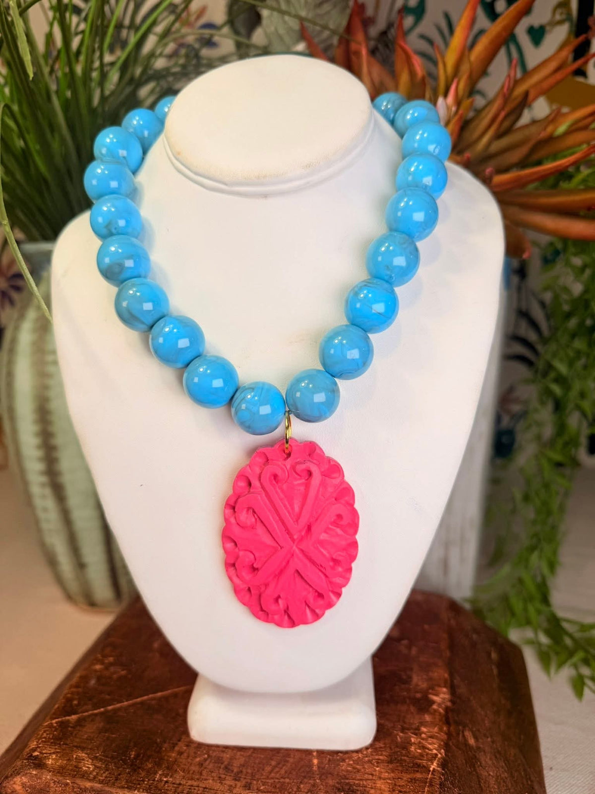Pink statement pendant with blue beaded necklace